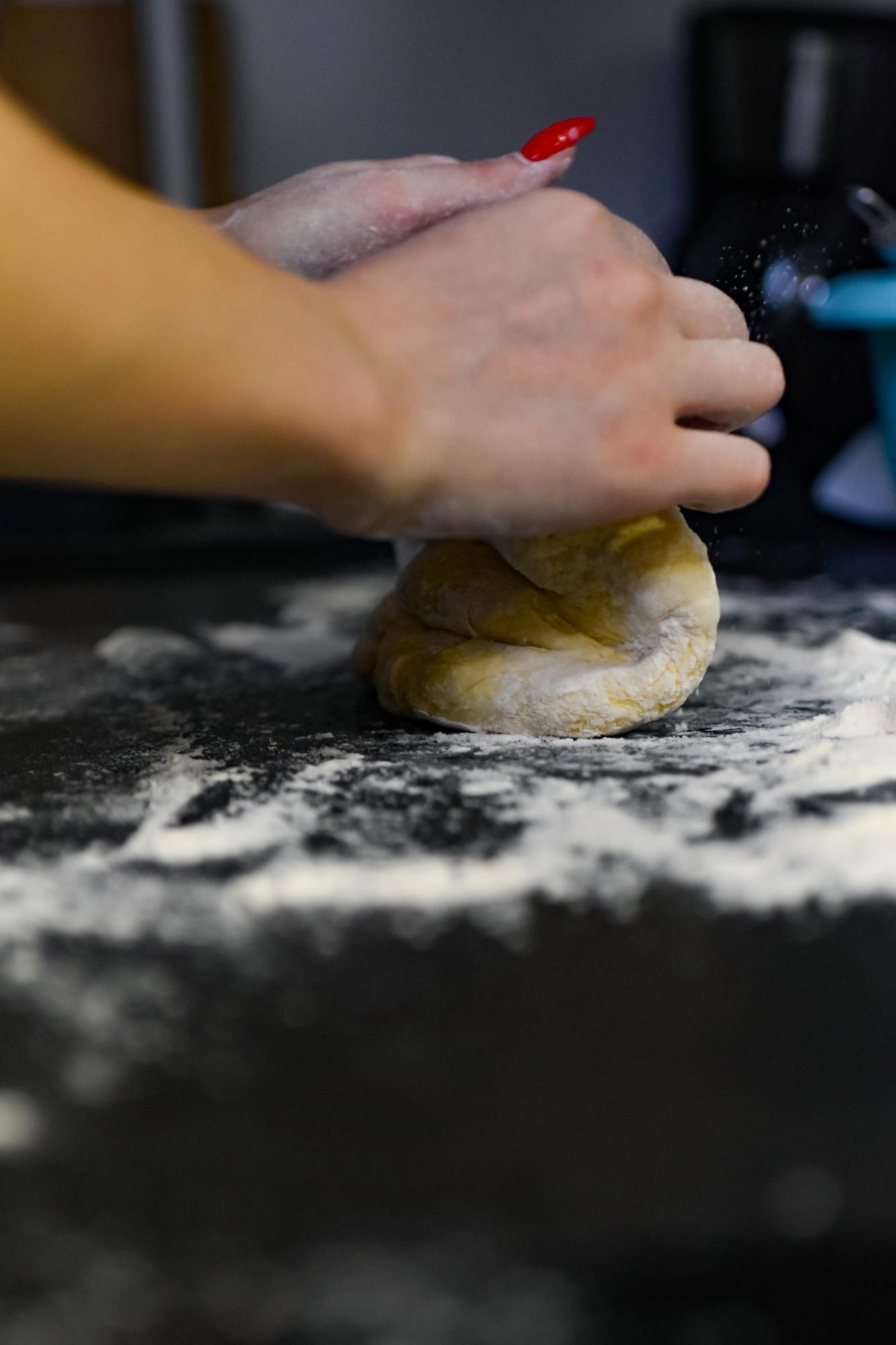 Hands preparing dough